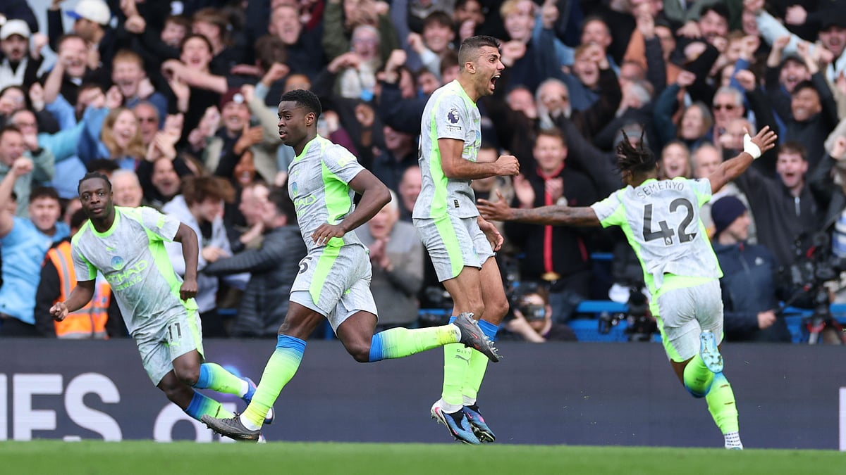 | Photo: AP/Ian Walton : Manchester City's Marc Guehi, left, and Jeremy Doku celebrate after scoring during the Premier League soccer match between Chelsea and Manchester City in London, Sunday, April 12, 2026.