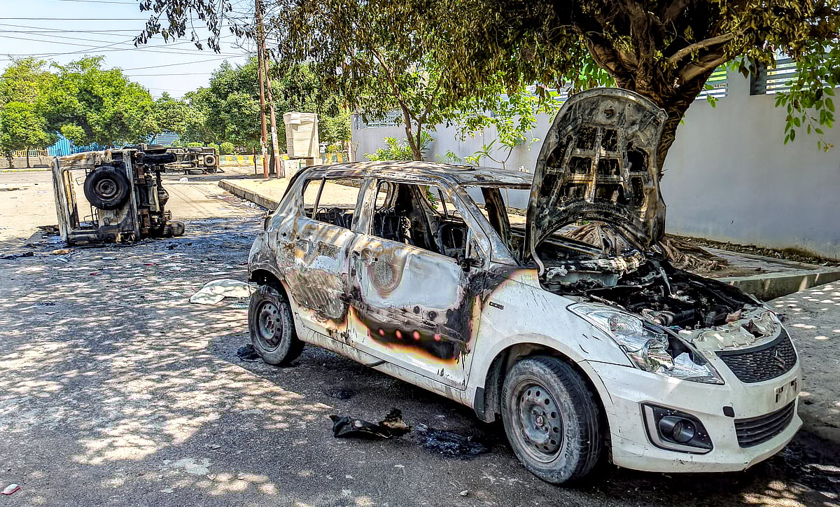 PTI : Noida: Wreckage of vehicles is seen after they were burnt during a protest by factory workers demanding a hike in wages, in Noida, Gautam Buddh Nagar district, Uttar Pradesh, Monday, April 13, 2026. The protest carried incidents of arson, vandalism and stone-pelting reported from Phase-2 and Sector 60 areas, police said. 