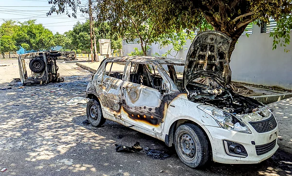 PTI : Noida: Wreckage of vehicles is seen after they were burnt during a protest by factory workers demanding a hike in wages, in Noida, Gautam Buddh Nagar district, Uttar Pradesh, Monday, April 13, 2026. The protest carried incidents of arson, vandalism and stone-pelting reported from Phase-2 and Sector 60 areas, police said.