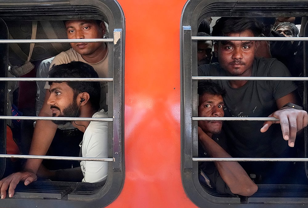 SURESH K PANDEY : Young men look out from the crowded train window after just boarding, their faces tired, sitting packed inside the general coach. 