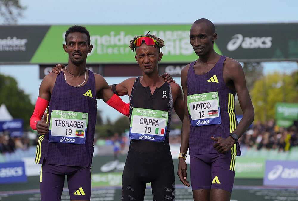 | Photo: AP/Thibault Camus : From left, Ethiopias Bayelign Teshager, Italys Yemaneberhan Crippa and Kenyas Sila Kiptoo pose after crossing the finish line of the mens race of the Paris marathon, in Paris.