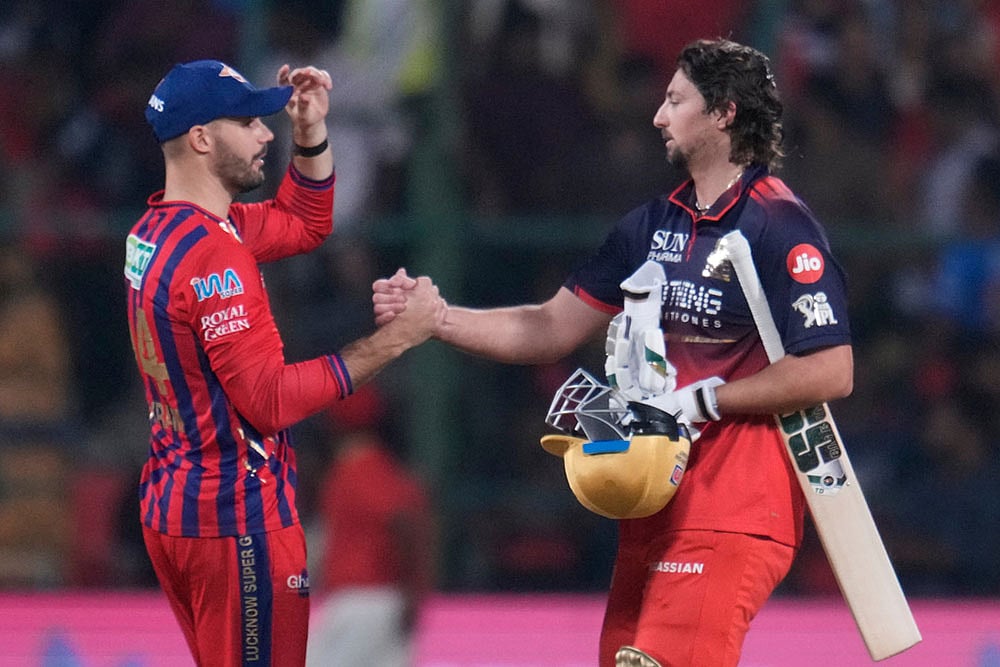 | Photo: AP/Aijaz Rahi : Royal Challengers Bengalurus Tim David, right, shake hands with Lucknow Super Giants Aiden Markram at the end of the Indian Premier League cricket match against Lucknow Super Giants in Bengaluru, India.