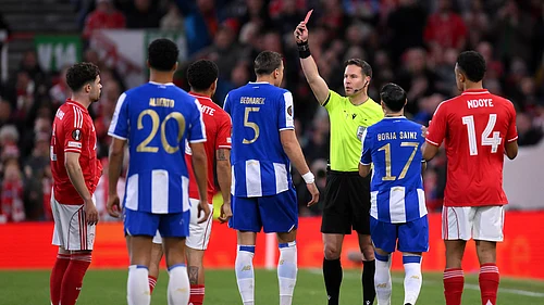 Gary Oakley/PA via AP : Jan Bednarek, center, is shown a red card and sent off by referee Danny Makkelie during the Europa League quarterfinal second leg soccer match.