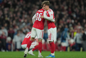 | Photo: AP/Kin Cheung : Arsenal's Martin Zubimendi, left, and Max Dowman hug afterthe UEFA Champions League second leg quarterfinal soccer match between Arsenal and Sporting in London, England.