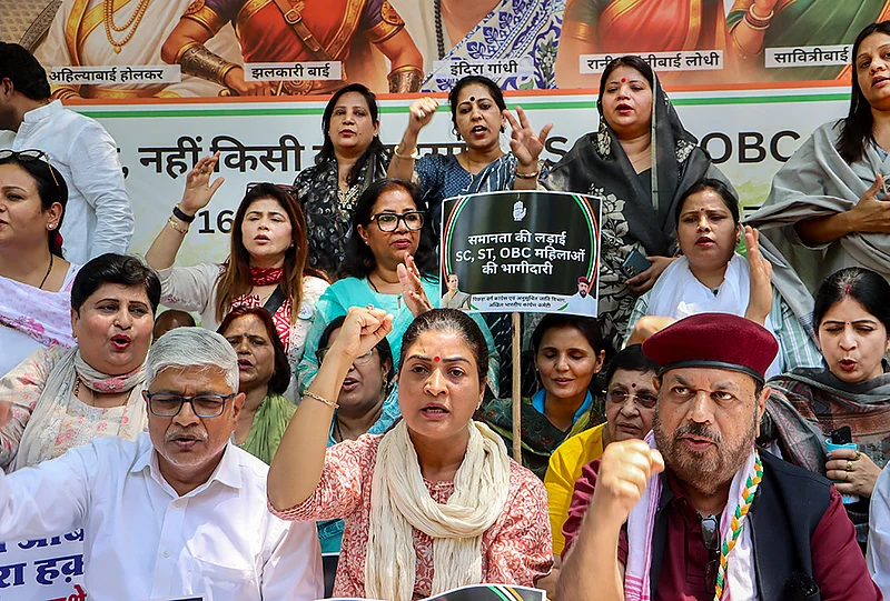 | Photo: PTI : Congress leader Alka Lamba, front centre, and others stage a protest demanding SC/ST reservation in the 'Nari Shakti Vandan Adhiniyam', commonly known as the Women's Reservation Act, in New Delhi. A special three-day sitting of Parliament is being held from April 16 to 18, during which amendments to the Act, mandating 33 per cent reservation for women in Lok Sabha and state Assemblies, will be brought for implementation in 2029.