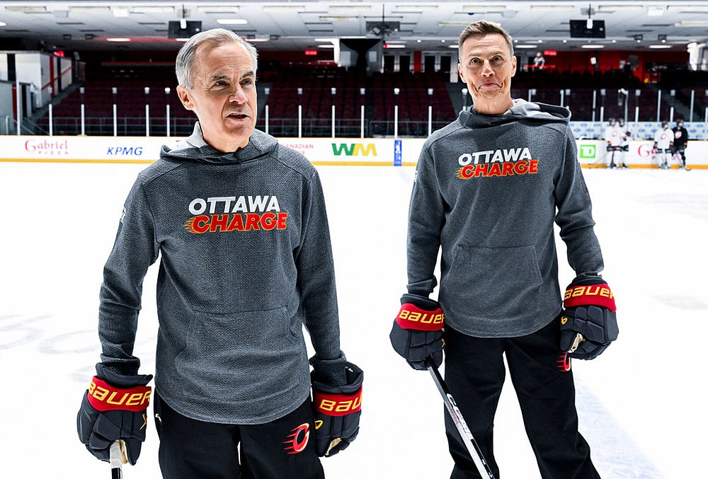 | Photo: Spencer Colby/The Canadian Press via AP : Canada Prime Minister Mark Carney, left, and President of Finland Alexander Stubb speak to reporters as they participate in an Ottawa Charge hockey practice session at TD Place in Ottawa. 