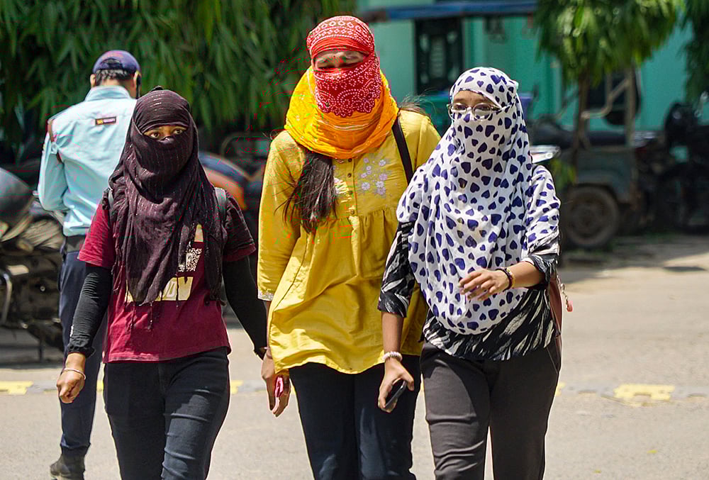| Photo: PTI : Women cover themselves amid heat on a hot summer day, in Varanasi, Uttar Pradesh.