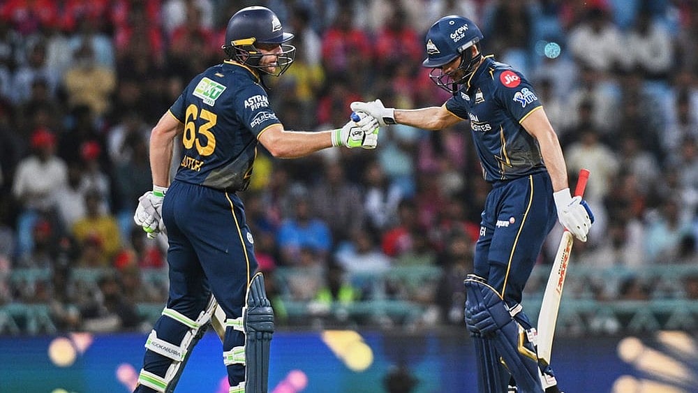 | Photo: AP/STR : Gujarat Titans Jos Buttler congratulates captain Shubman Gill after his fifty runs during the Indian Premier League cricket match between Gujarat Titans and Lucknow Super Giants in Lucknow, India.