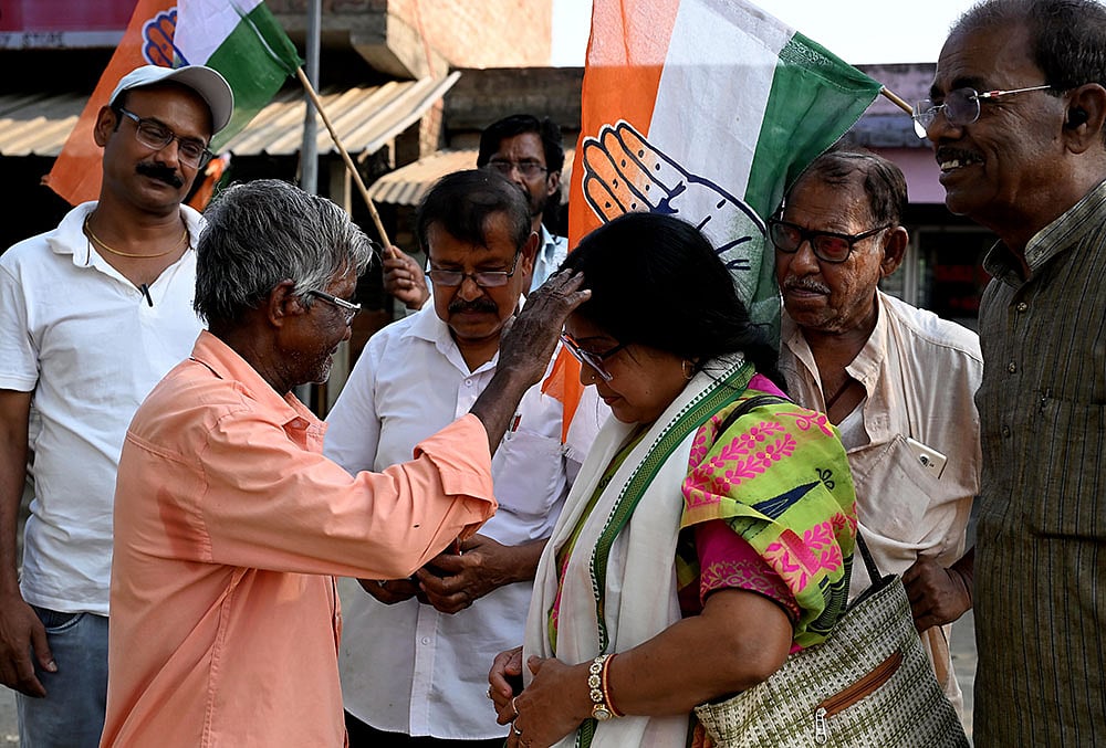 | Photo: PTI : Congress candidate from the Ranaghat Dakshin Assembly constituency, Rita Pal Das, campaigns ahead of the West Bengal Assembly elections, in Nadia, West Bengal.