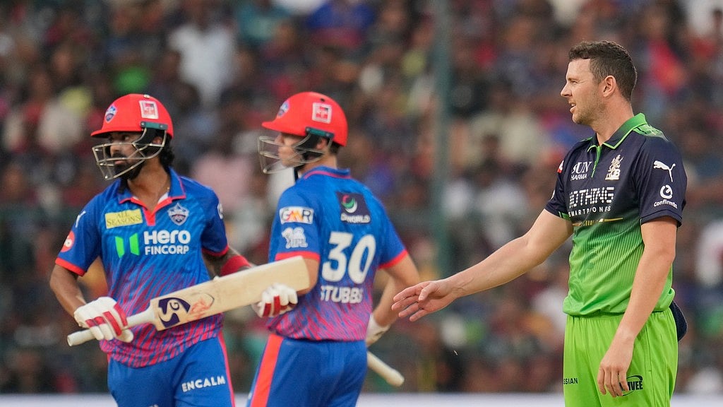 AP Photo/Aijaz Rahi : Royal Challengers Bengalurus Josh Hazlewood reacts after a delivery during the Indian Premier League cricket match between Royal Challengers Bengaluru and Delhi Capitals in Bengaluru, India, Saturday, April 18, 2026.