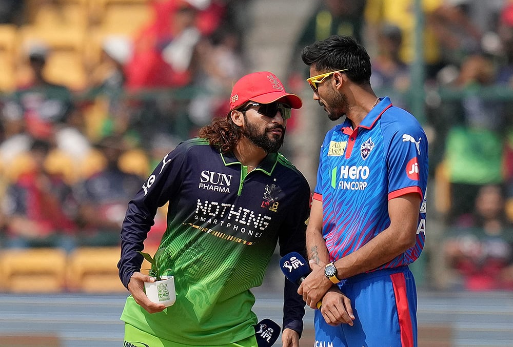 | Photo: PTI/Shailendra Bhojak : Royal Challengers Bengalurus captain Rajat Patidar, left, and Delhi Capitals captain Axar Patel during the toss before an Indian Premier League (IPL) 2026 T20 cricket match between Royal Challengers Bengaluru and Delhi Capitals, in Bengaluru, Karnataka.
