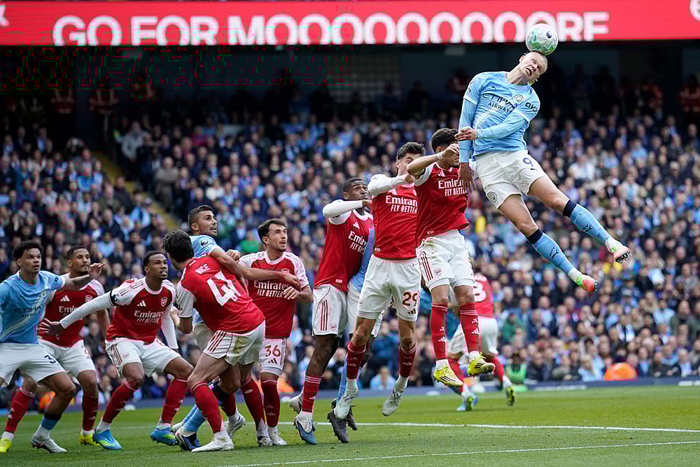 | Photo: AP/Dave Thompson : Manchester Citys Erling Haaland heads the ball during the English Premier League soccer match between Manchester City and and Arsenal, in Manchester, England.
