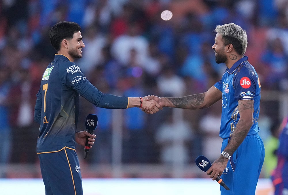 | Photo: AP/Ajit Solanki : Gujarat Titans captain Shubman Gill, left, shake hands with Mumbai Indians captain Hardik Pandya after the toss before the start the Indian Premier League cricket match between Gujarat Titans and Mumbai Indians in Ahmedabad.