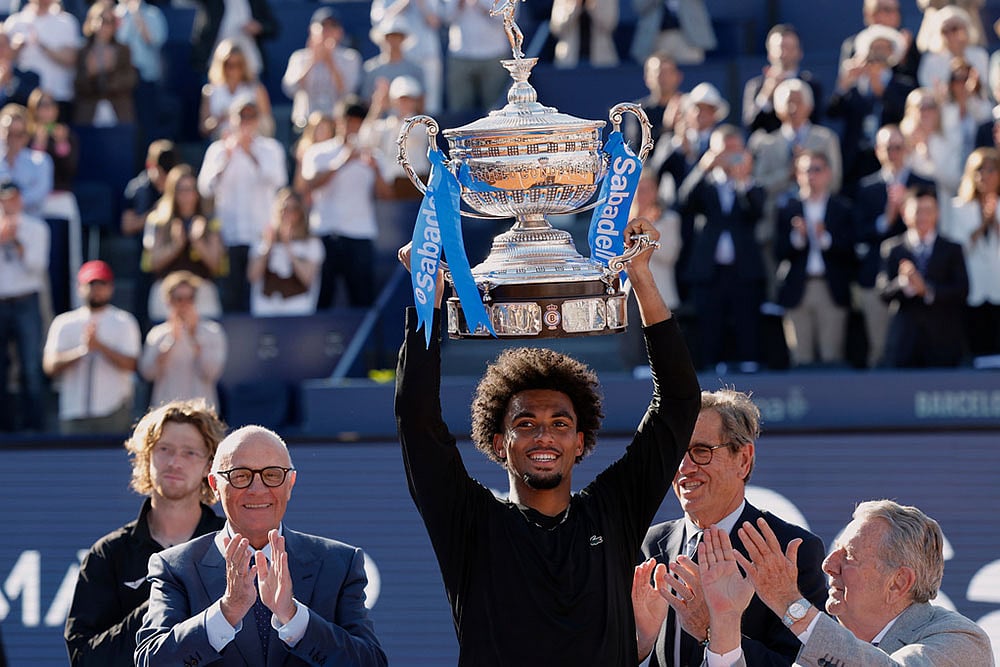 | Photo: AP/Joan Monfort : Frances Arthur Fils lifts the trophy after defeating Russias Andrey Rublev in the ATP Barcelona Open tennis final in Barcelona, Spain.