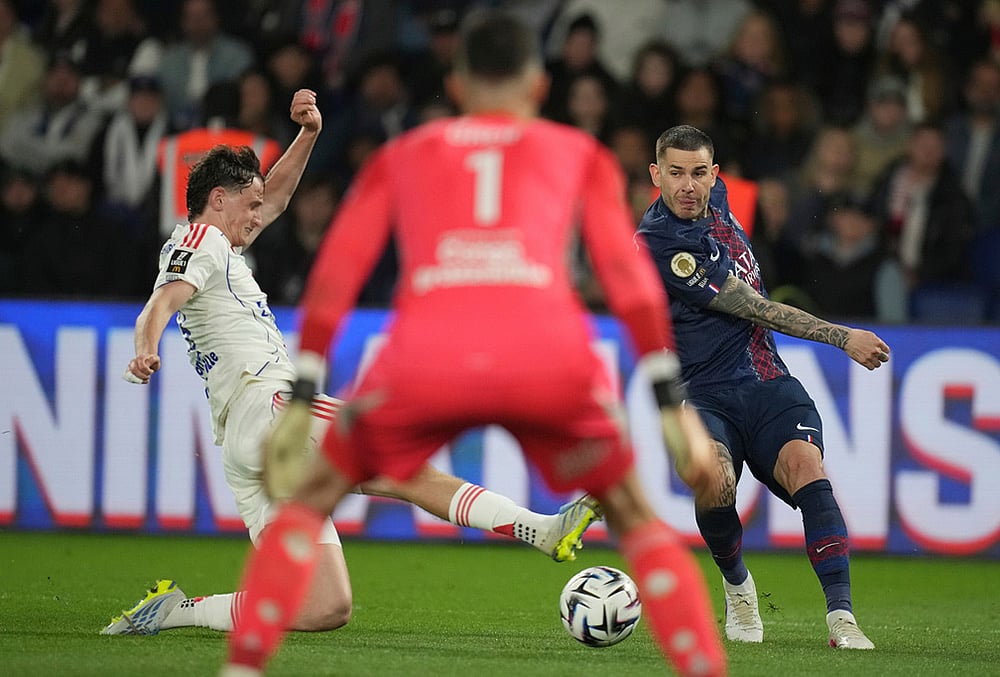 | Photo: AP/Christophe Ena : Lyons Thiago Almada, left, and PSGs Vitinha, right, challenge for the ball during the French League One soccer match between Paris Saint-Germain and Olympique Lyon in Paris, France.