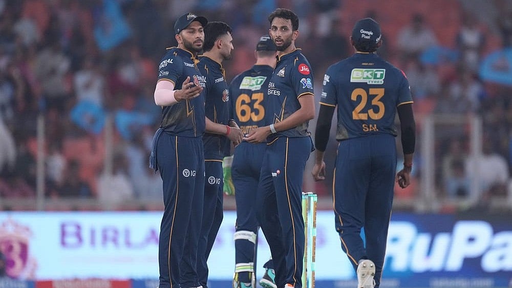 | Photo: AP/Ajit Solanki : Gujarat Titans Prasidh Krishna, centre, celebrates with teammates the wicket of Mumbai Indians Naman Dhir during the Indian Premier League cricket match between Gujarat Titans and Mumbai Indians in Ahmedabad.