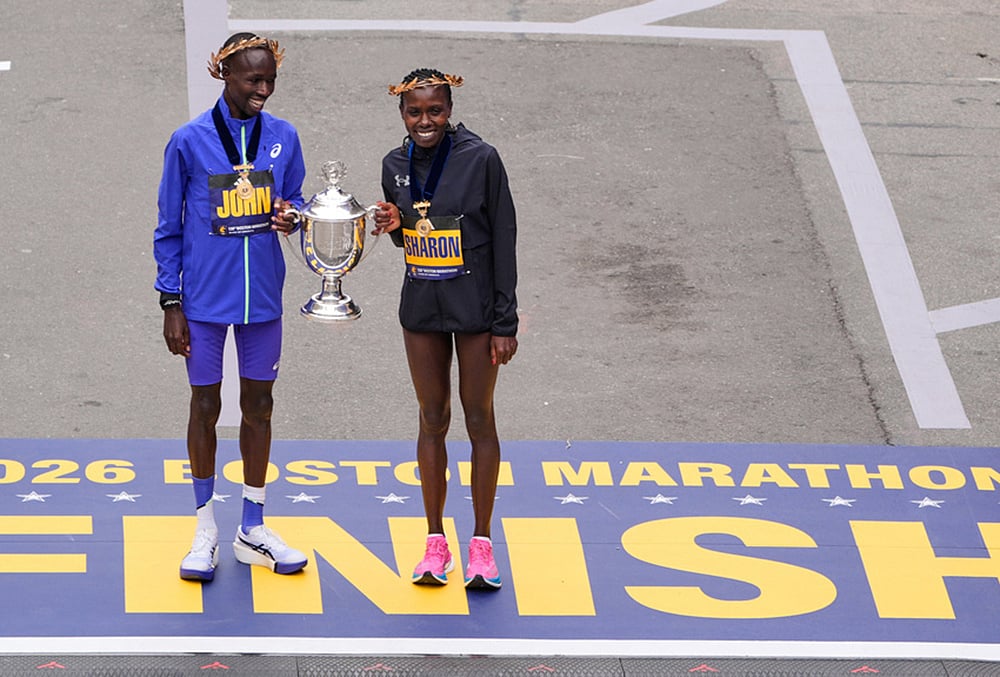 | Photo: AP/Charles Krupa : Boston Marathon winner John Korir of Kenya, left, holds the trophy with womens division winner Sharon Lokedi, also of Kenya, at the finish line of the Boston Marathon, in Boston. 