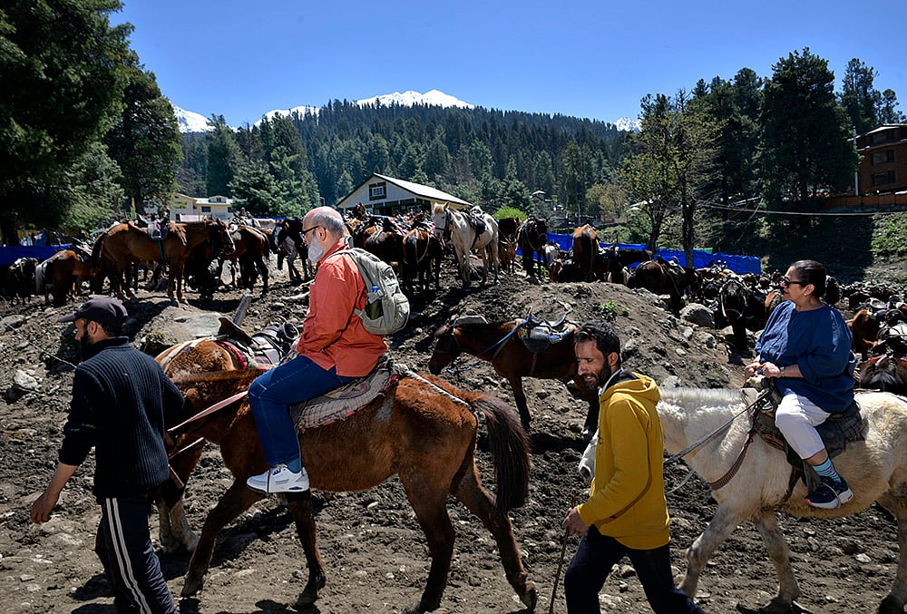 | Photo: Yasir Iqbal : Tourists enjoy a horse ride through the scenic trails of Pahalgam. A year after the attacks, the region’s tourism revival is slowly gaining momentum, bringing a sense of hope back to the local community.