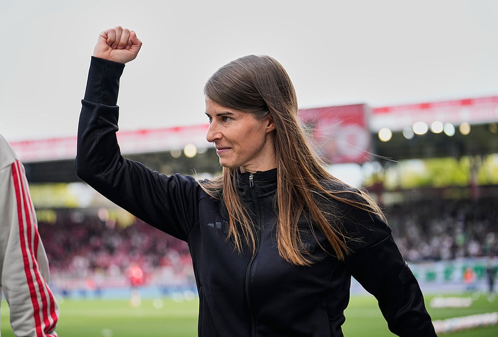 | Photo: AP/Ebrahim Noroozi : New head coach of German Bundesliga soccer club 1. FC Union Berlin Marie-Louise Eta looks on during the warm up prior to the German Bundesliga soccer match between FC Union Berlin and Wolfsburg in Berlin, Germany, Saturday, April 18, 2026. 