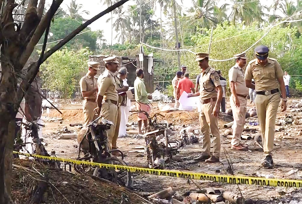 | Photo: PTI : Police officials conduct a search operation after a blast at a fireworks manufacturing unit on Tuesday night, at Mundathicode in central Kerala’s Thrissur district. At least 13 people were killed and several others were injured in the incident. 