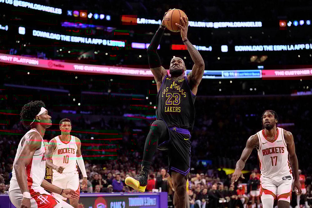 | Photo: AP/Mark J. Terrill : Los Angeles Lakers forward LeBron James, second from right, shoots as Houston Rockets guard Amen Thompson, left, forward Jabari Smith Jr., second from left, and forward Tari Eason defend during the second half in Game 2 of a first-round NBA playoffs basketball series in Los Angeles.