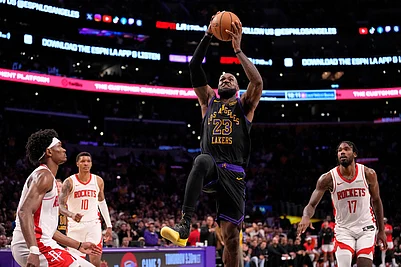 | Photo: AP/Mark J. Terrill : Los Angeles Lakers forward LeBron James, second from right, shoots as Houston Rockets guard Amen Thompson, left, forward Jabari Smith Jr., second from left, and forward Tari Eason defend during the second half in Game 2 of a first-round NBA playoffs basketball series in Los Angeles.