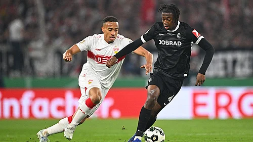 Photo: Tom Weller/dpa via AP : Freiburgs Johan Manzambi, right, turns away Stuttgarts Jamie Leweling during their German Cup semi-final match.