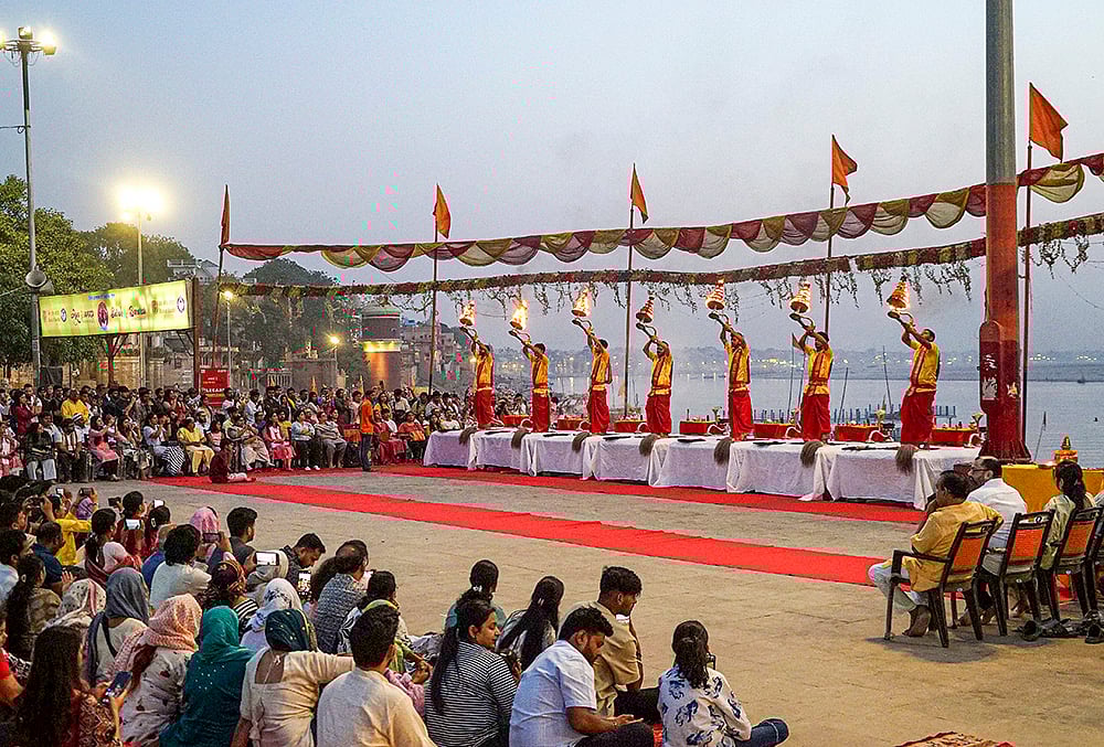 | Photo: PTI : Priests perform ‘aarti’ during the ‘Ganga Saptami’ festival, at Assi Ghat in Varanasi.