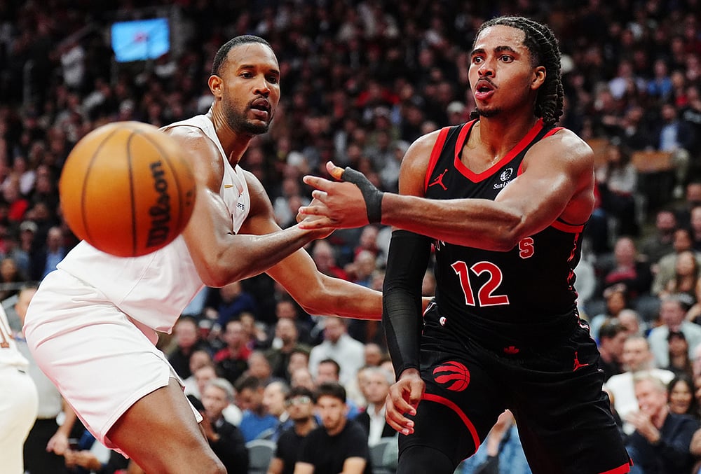 | Photo: Frank Gunn/The Canadian Press via AP : Toronto Raptors Collin Murray-Boyles (12) passes around Cleveland Cavaliers Evan Mobley (4) during the second half of an NBA basketball playoff game in Toronto.