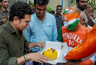 | Photo: AP/Kunal Patil : Mumbai: Cricketer Sachin Tendulkar celebrates his birthday with his fan Sudhir, right, at his residence, in Mumbai.