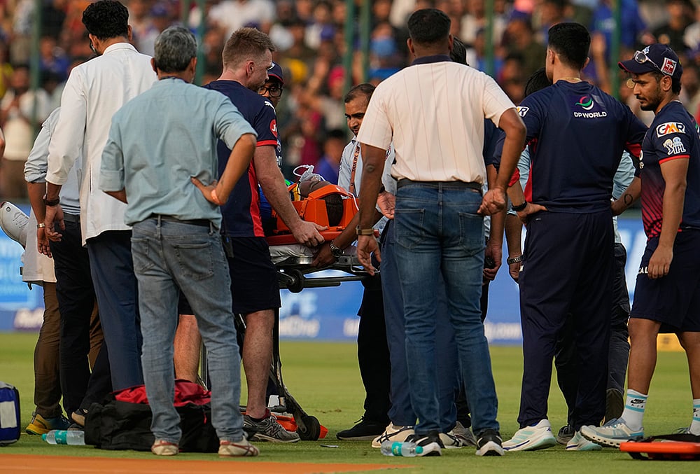 | Photo: AP/Manish Swarup : Delhi Capitals Lungi Ngidi is carried on a stretcher after he was injured during the Indian Premier League cricket match between Delhi Capitals and Punjab Kings in New Delhi.