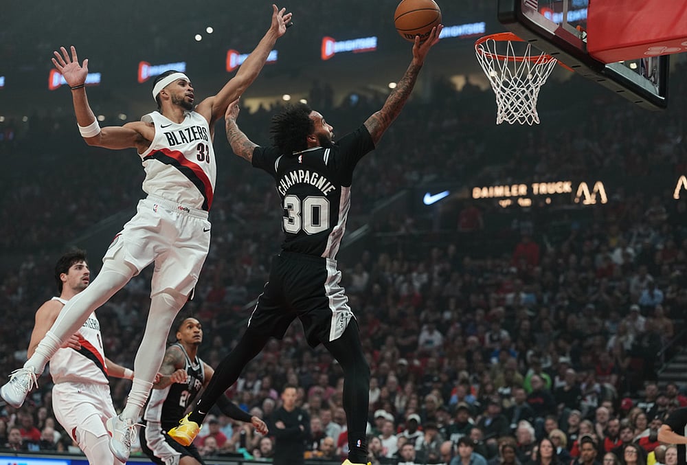 | Photo: AP/Jenny Kane : San Antonio Spurs forward Julian Champagnie (30) drives to the basket past Portland Trail Blazers forward Toumani Camara (33) during the second half in Game 3 of a first-round NBA playoffs basketball series in Portland, Oregon.