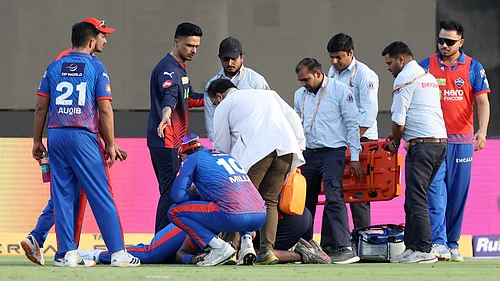 IPL/X : Lungi Ngidi receiving treatment inside the field after suffering head injury during the DC vs PBKS match while taking a catch.