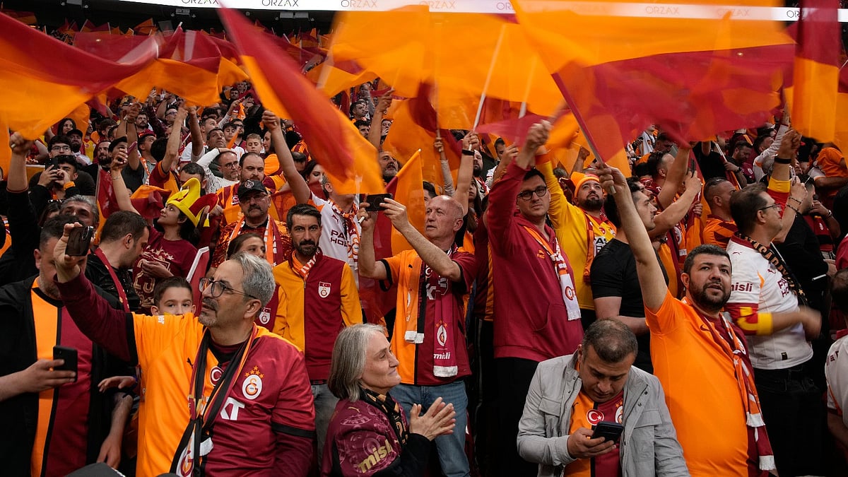 AP Photo : Galatasaray supporter cheer prior a Turkish Super Lig soccer match between Galatasaray and Fenerbahce in Istanbul, Turkey.