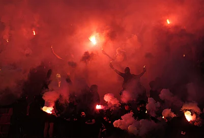 | Photo: AP/Darko Vojinovic : Partizan fans light fireworks during a Serbian National soccer league derby match between Red Star and Partizan in Belgrade, Serbia.