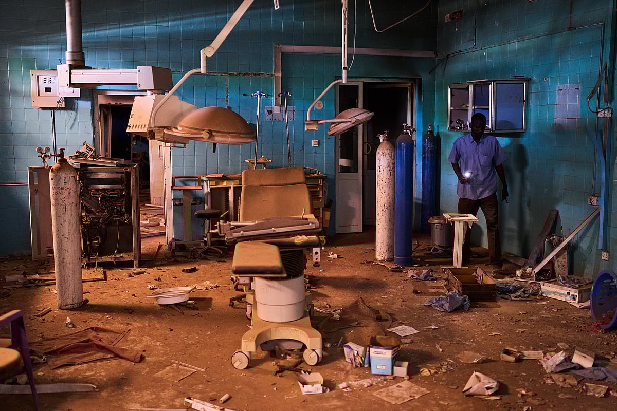 AP : A guard walks through a war-damaged section of Al Shaabi Hospital in Khartoum