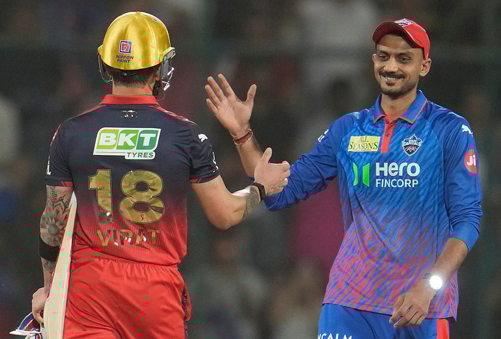 | Photo: AP/Manish Swarup : Delhi Capitals captain Axar Patel, right, shake hands with Royal Challengers Bengalurus Virat Kohli after Royal Challengers Bengaluru won the match during the Indian Premier League cricket match between Delhi Capitals and Royal Challengers Bengaluru in Delhi.