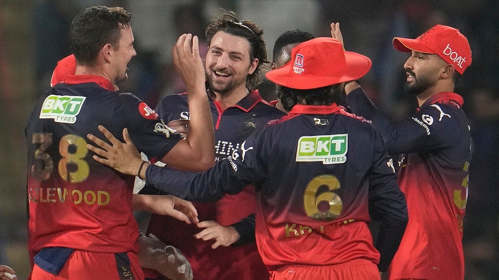 AP/Manish Swarup : Josh Hazlewood, left, celebrates with teammates the wicket of Nitish Rana during the Indian Premier League match between Delhi Capitals and Royal Challengers Bengaluru in Delhi.