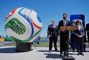 | Photo: AP/Seth Wenig : New York City Mayor Zohran Mamdani, second from left, speaks next to a large soccer ball during a news conference in the Staten Island borough of New York.