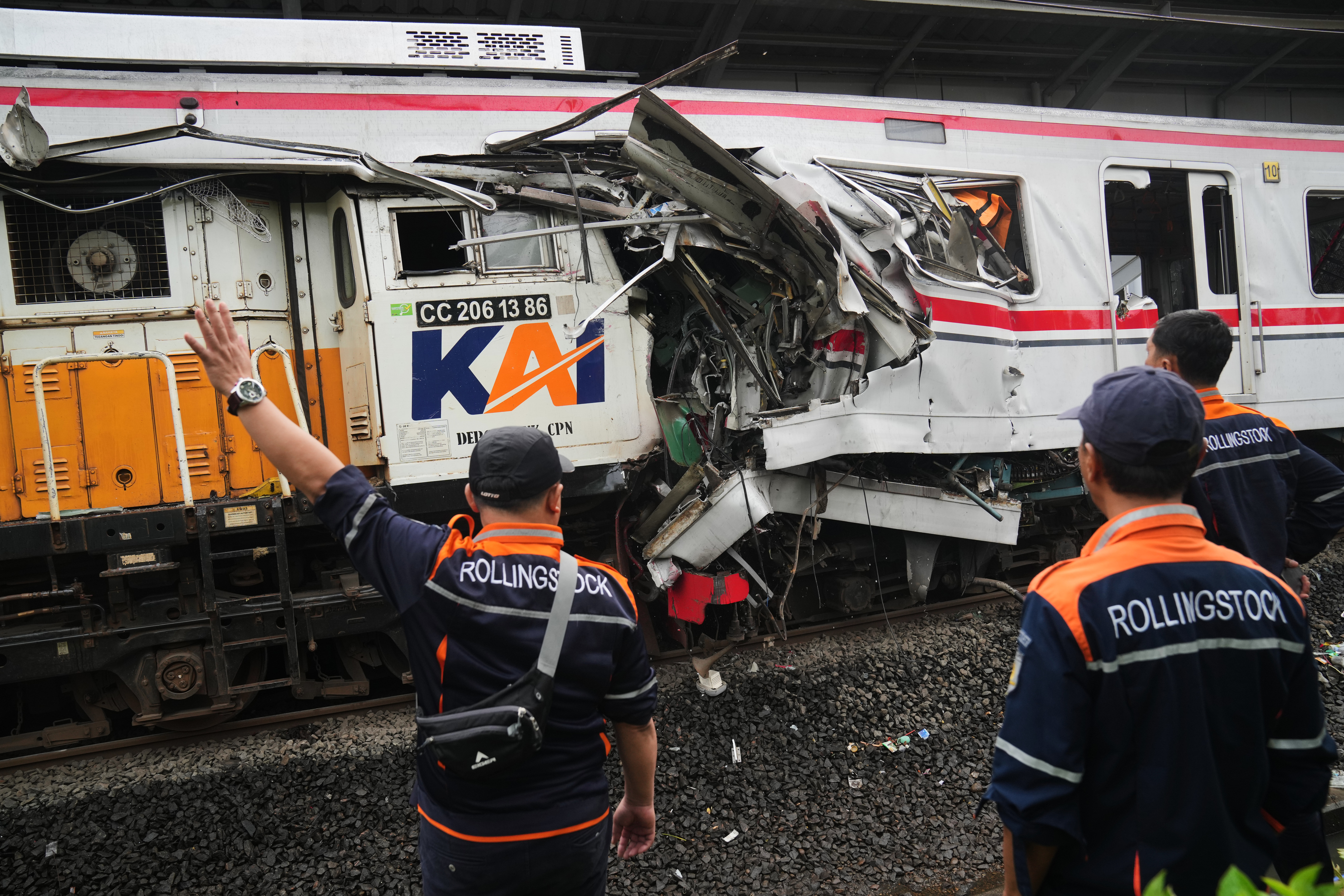 AP : Workers examine the wreckages of trains after a collision in Bekasi, Indonesia