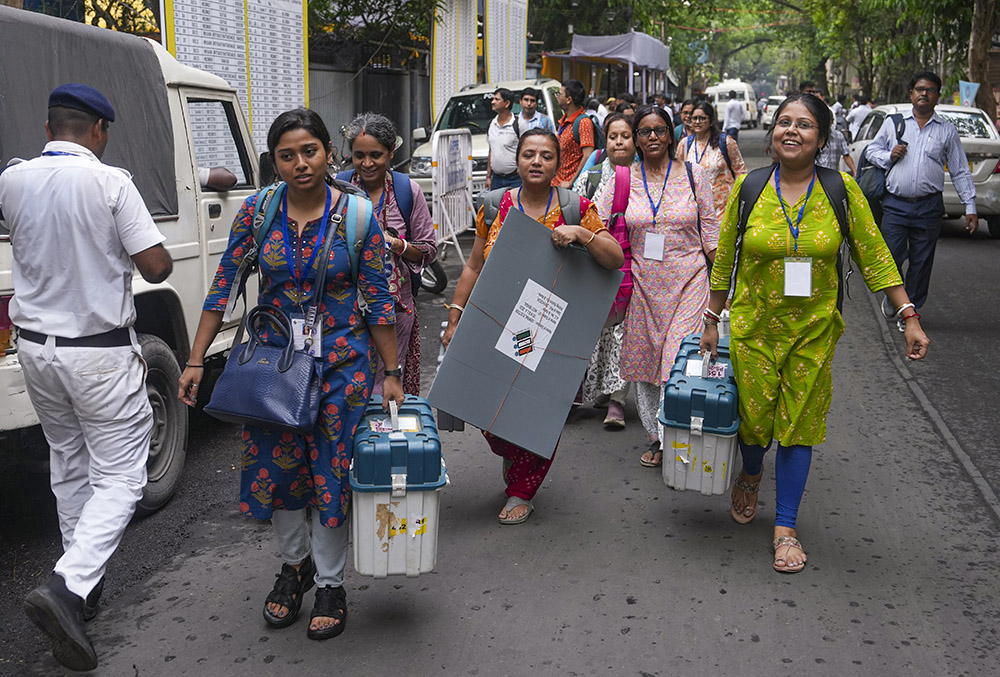 | Photo: PTI/Manvender Vashist Lav : Officials leave for their respective polling stations after collecting Electronic Voting Machine (EVM) and Voter Verifiable Paper Audit Trail (VVPAT) units for voting in the second phase of the West Bengal Assembly elections, in Kolkata.