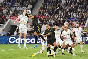 | Photo: AP/Jae C. Hong : LAFC forward Son Heung-Min (7) and Toluca midfielder Marcel Ruiz (14) jump for a header during the second half of the first leg of a CONCACAF Champions Cup semifinal soccer match in Los Angeles.