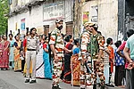 | Photo: Sandipan Chatterjee : Guns and Forces: Voters line up to cast their vote in the second phase of the West Bengal election amid heavy security