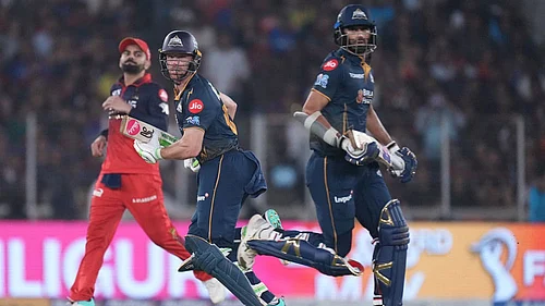 | Photo: AP/Ajit Solanki : Gujarat Titans Washington Sundar, right, and Jos Buttler run between the wickets during the Indian Premier League cricket match between Gujarat Titans and Royal Challengers Bengaluru in Ahmedabad, India.