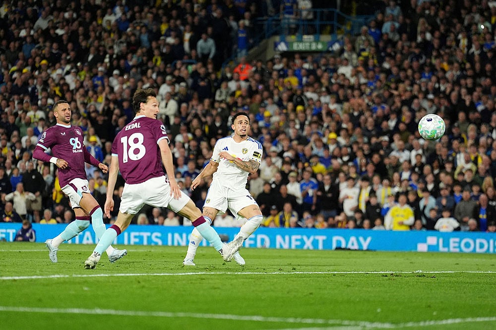 | Photo: Martin Rickett/PA via AP : Leeds Uniteds Noah Okafor, right, scores their sides second goal during the Premier League match between Leeds United and Burnley, in Leeds, England.