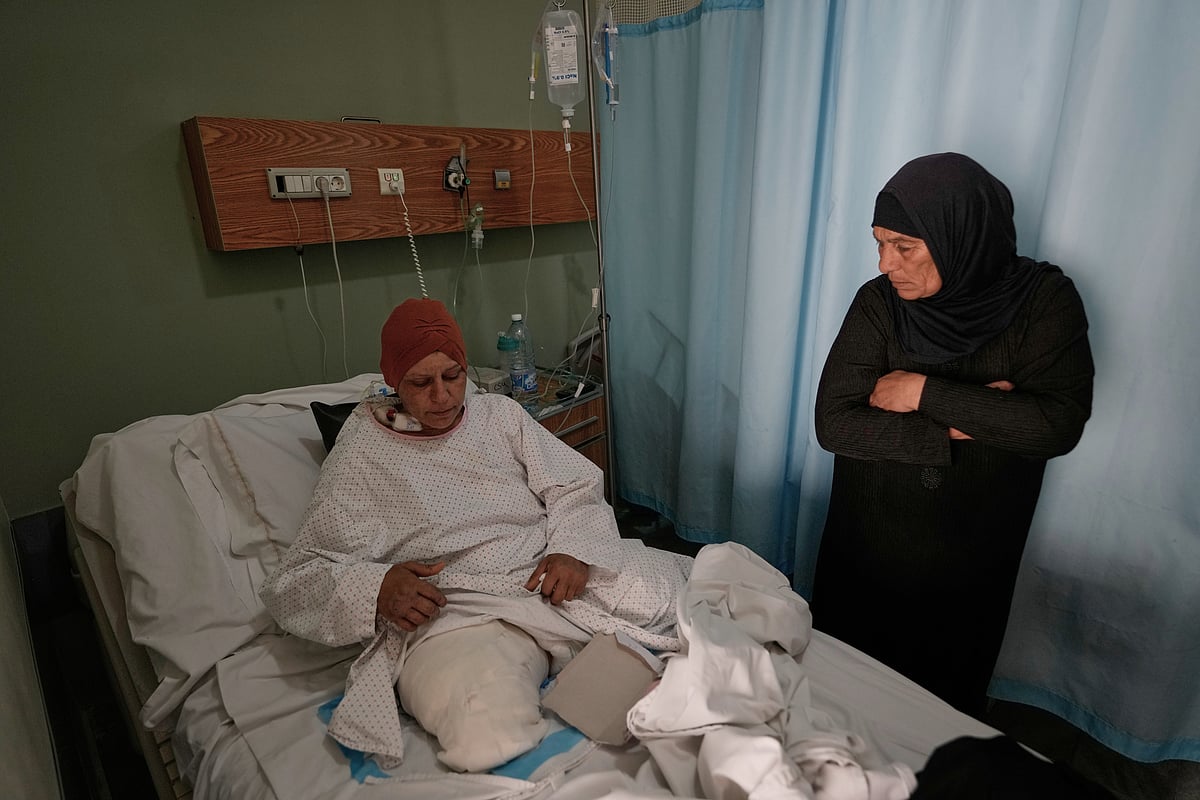Hussein Malla; AP : Sanaa Khalil, 35, a Syrian farmer who lost her two legs in the past days by an Israeli airstrike while she was working at a banana plantation, lies on a bed as she is assisted by a relative at a hospital in the southern port city of Tyre, Lebanon, Friday, May 1, 2026.