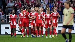 AP/Matthias Schrader : Franziska Kett, centre, celebrates after scoring her side's first goal during the Women's Champions League semi-final first-leg match between Bayern Munich and Barcelona in Munich.