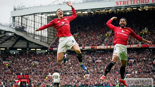 | Photo: AP/Dave Thompson : Manchester Uniteds Benjamin Sesko, centre, celebrates with Manchester Uniteds Matheus Cunha after scoring his sides second goal during the English Premier League soccer match between Manchester United and Liverpool in Manchester, England, Sunday, May 3, 2026.