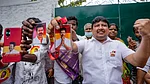 Photo: PTI : Supporters hold portraits of Tamilaga Vettri Kazhagam (TVK) chief Vijay during vote tabulation on the day of Assembly election results, in Chennai, Monday, May 4, 2026.