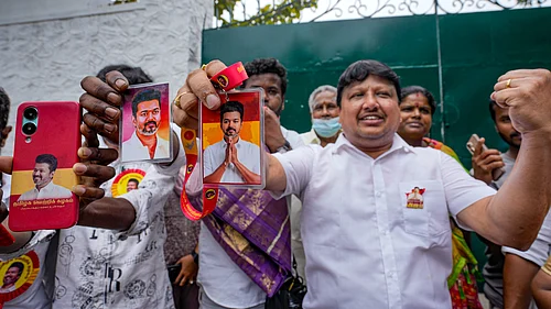 Photo: PTI : Supporters hold portraits of Tamilaga Vettri Kazhagam (TVK) chief Vijay during vote tabulation on the day of Assembly election results, in Chennai, Monday, May 4, 2026.